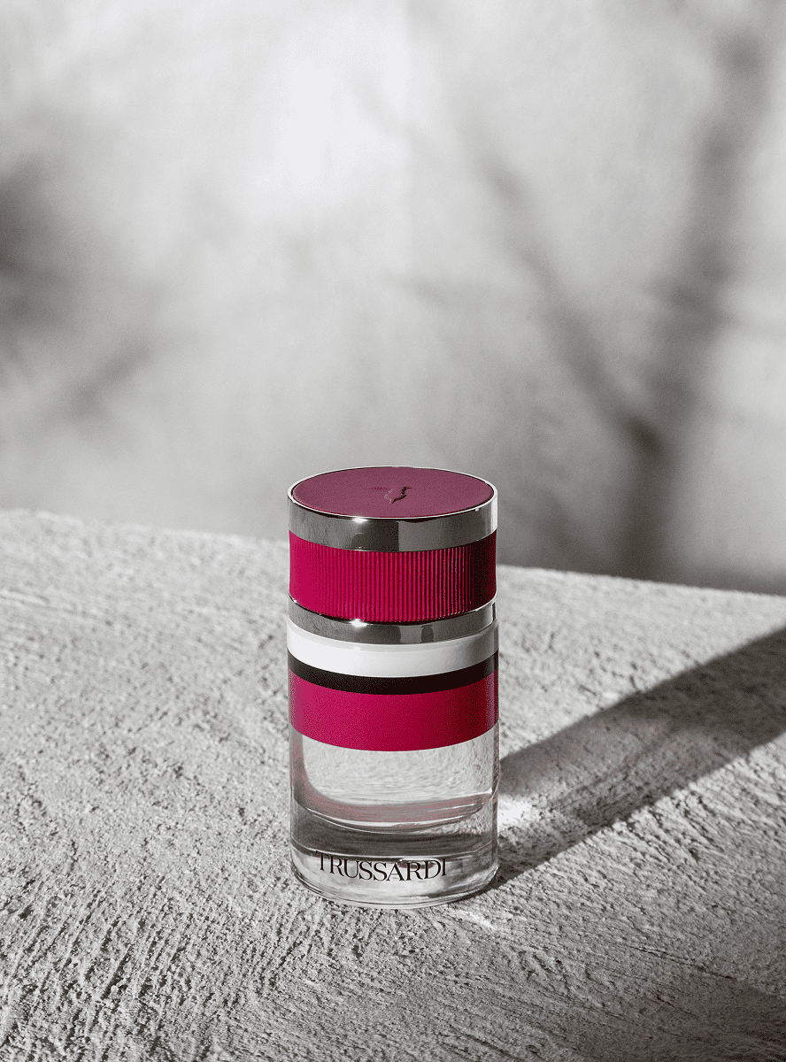 Bottle of Trussardi Ruby Red Eau de Parfum 60ml with red background - thumbnail 3